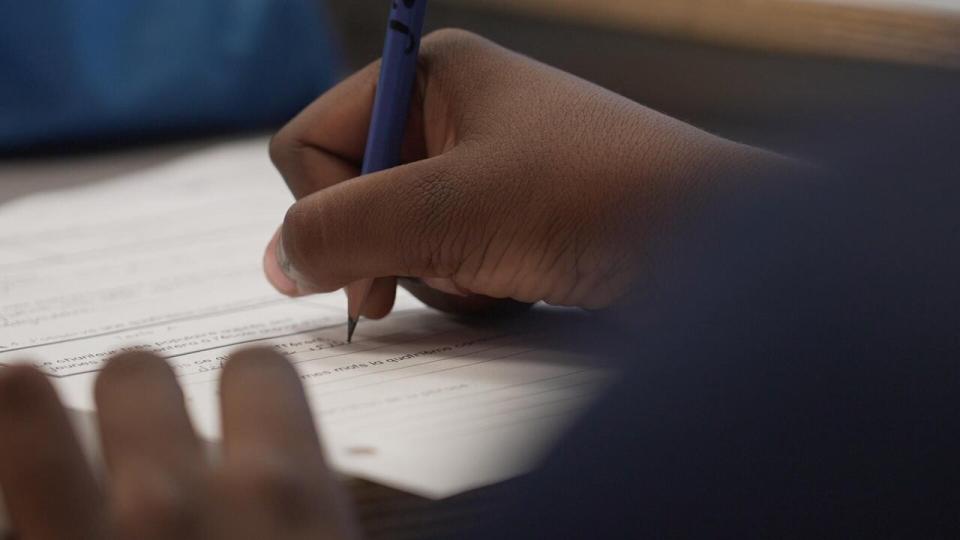 A file photo shows an elementary student writing on a worksheet. Students in grades kindergarten to Grade 2 will have an extra hour added to their school days beginning in the fall. 