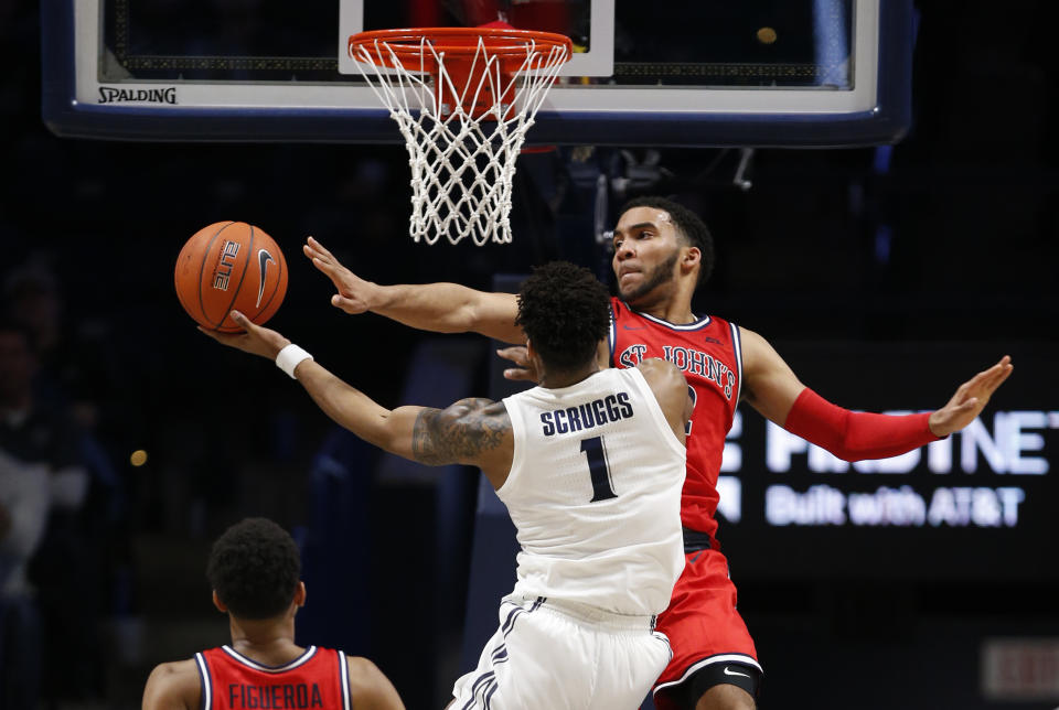 Xavier guard Paul Scruggs (1) attempts to shoot against St. John's guard Julian Champagnie, right, during the second half of an NCAA college basketball game, Sunday, Jan. 5, 2020, in Cincinnati. (AP Photo/Gary Landers)