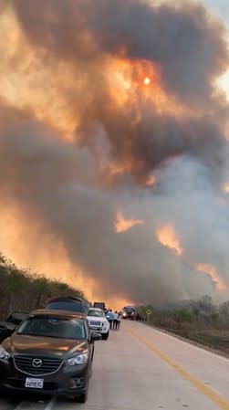 Smoke is seen during wildfires in Aguas Calientes in Santa Cruz