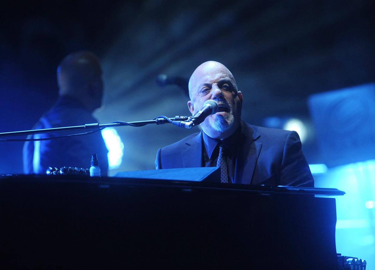 Musician Billy Joel performs at Madison Square Garden on December 18, 2014 in New York City.