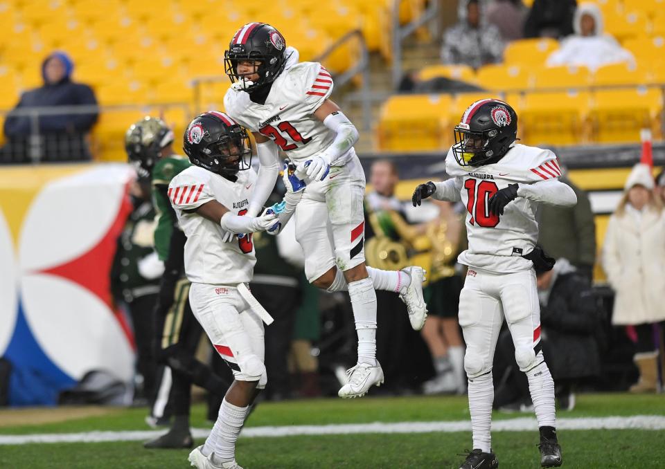 The Quips celebrate Donovan Walker's touchdown catch against Belle Vernon in the last few seconds of the first half during Saturday's WPIAL Class 4A championship game at Heinz Field.