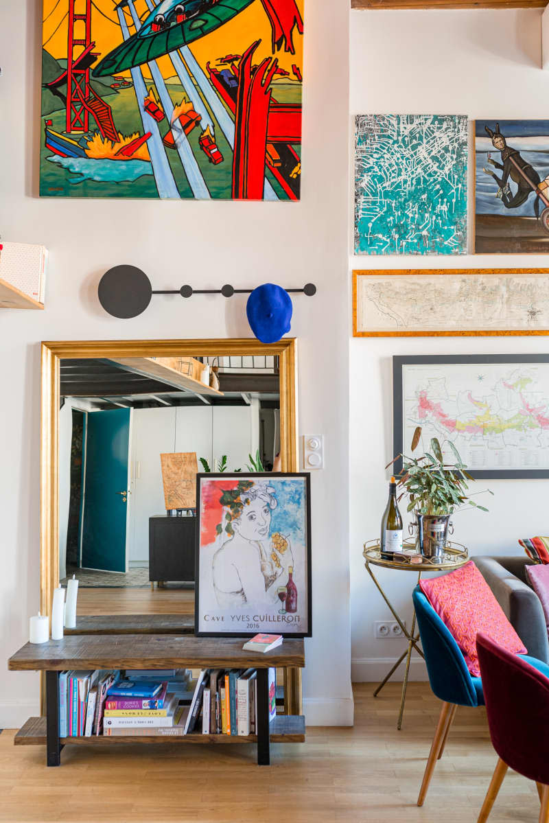 Living room wall with framed and colorful framed art pieces.