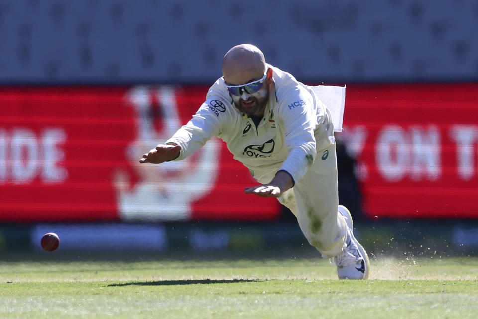 Australia's Nathan Lyon makes a fielding attempt during the fourth day of their cricket test match against Pakistan in Melbourne, Friday, Dec. 29, 2023. (AP Photo/Asanka Brendon Ratnayake)