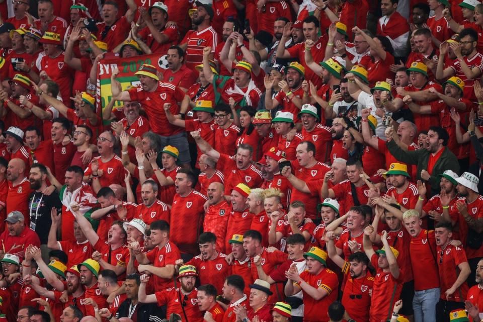 Wales supporters sing their national anthem ahead of the Qatar 2022 World Cup  match between USA and Wales (AFP via Getty Images)