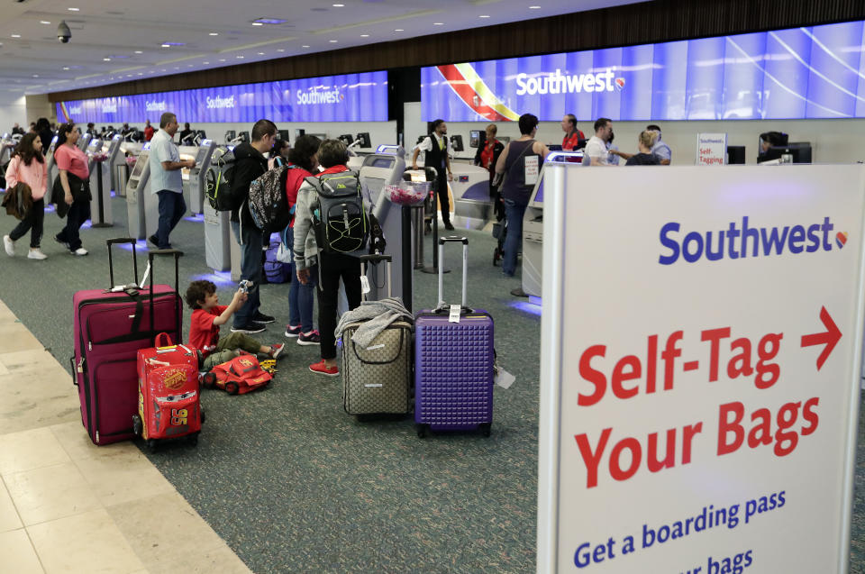 Travelers check in for flights at Orlando International Airport before the start of the Thanksgiving holiday Wednesday, Nov. 21, 2018, in Orlando, Fla. (AP Photo/John Raoux)