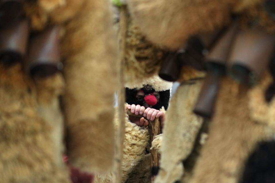 A reveler depicting the devil rests during a traditional St Nicholas procession near the village of Lidecko, Czech Republic, Sunday, Dec. 3, 2023. This pre-Christmas tradition has survived for centuries in a few villages in the eastern part of the country. (AP Photo/Petr David Josek)