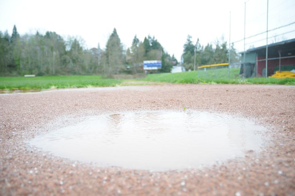 A puddle sits on a wet Gilmore Field Thursday afternoon, April 6, 2023.