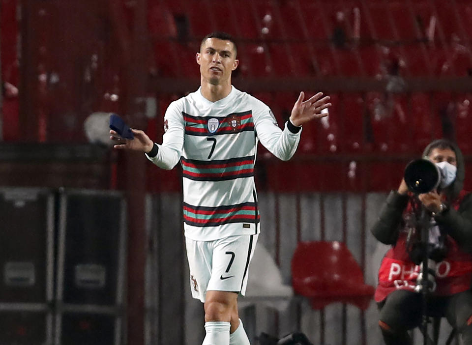 Portugal's Cristiano Ronaldo holding captain's armband, left, reacts during the World Cup 2022 group A qualifying soccer match against Serbia at the Rajko Mitic stadium in Belgrade, Serbia, Saturday, March 27, 2021. The captain’s armband which Cristiano Ronaldo threw to the pitch after his overtime winning goal was disallowed in a World Cup qualifier against Serbia has been put on auction Tuesday March 30, 2021. The armband is being auctioned by a charity group raising money for surgery of a six-month-old boy from Serbia suffering spinal muscular atrophy. (AP Photo/Darko Vojinovic)