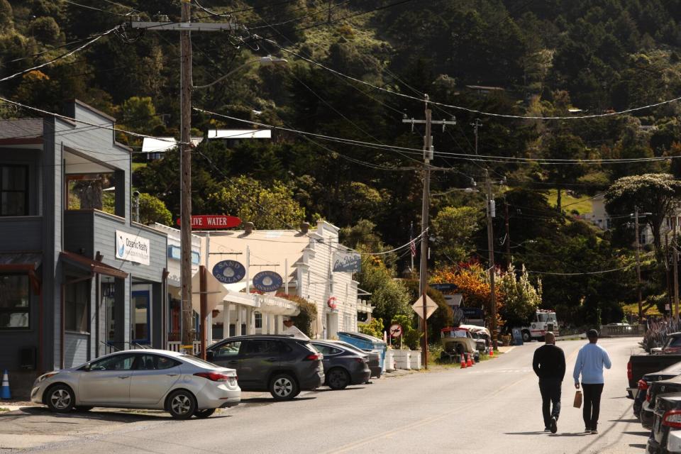 Visitors stroll through a quaint town.