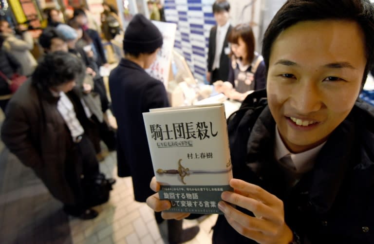 A fan of Haruki Murakami holds his new novel at a bookstore in Tokyo