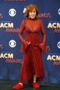 <p>At the 2018 ACM Awards, Reba performed in <a href="https://www.countryliving.com/life/entertainment/a19828326/reba-mcentire-performed-at-the-acm-awards-in-the-same-dress-she-wore-to-the-1993-cmas/" rel="nofollow noopener" target="_blank" data-ylk="slk:the same wow-worthy red dress;elm:context_link;itc:0;sec:content-canvas" class="link ">the same wow-worthy red dress</a> that turned heads back in 1993. But this time she added slippers.</p>