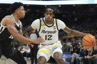 Marquette's Olivier-Maxence Prosper tries to get past Providence's Noah Locke during the first half of an NCAA college basketball game Wednesday, Jan. 18, 2023, in Milwaukee. (AP Photo/Morry Gash)