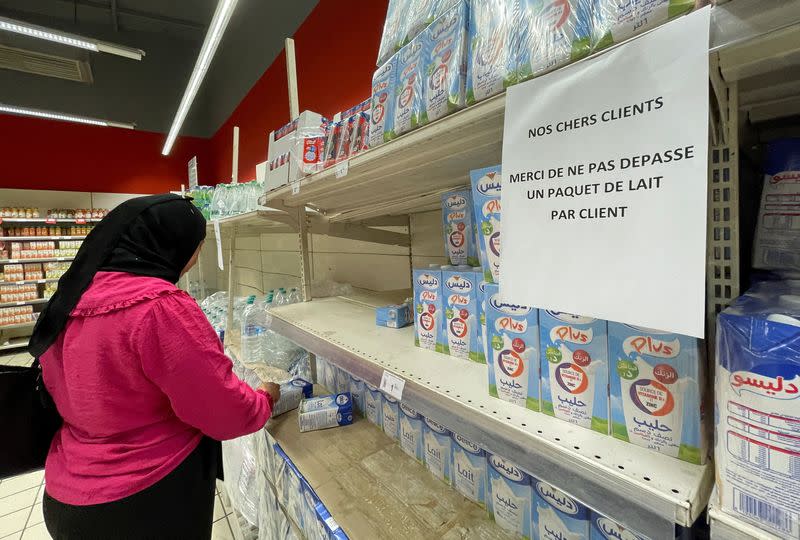 A woman stands at a supermarket in Tunis