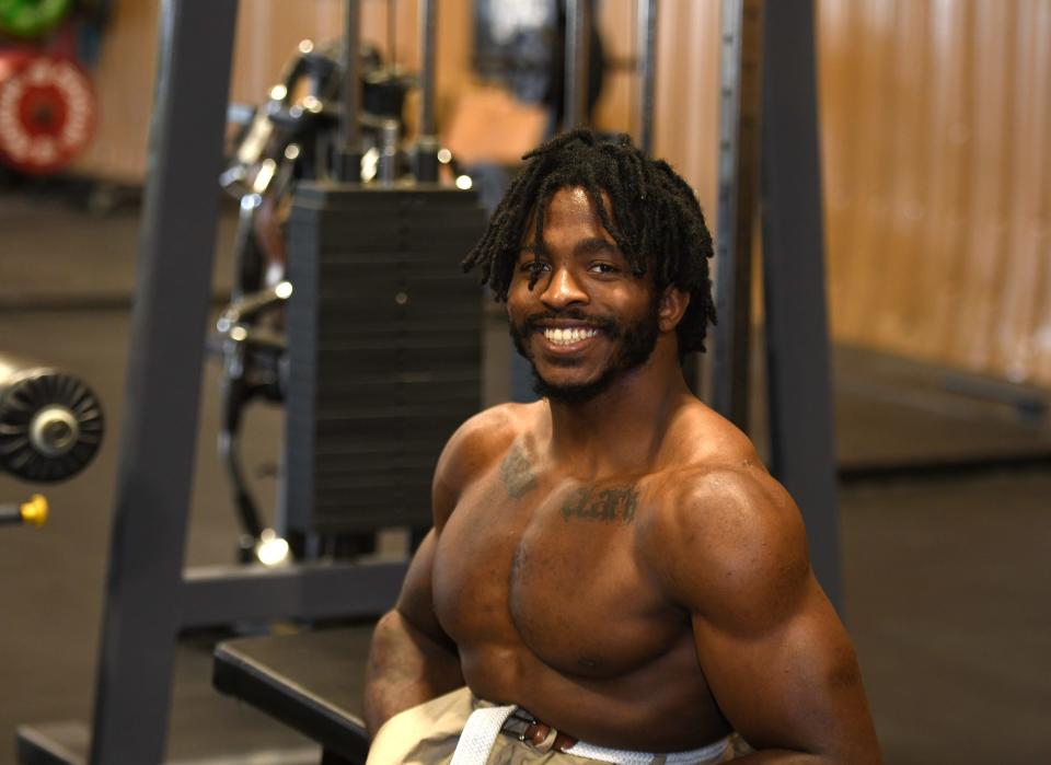 Zion Clark, who starred in wrestling and track at Massillon after being born without legs, takes a break from training for a July 8, 2021 photo at Rubber City Weightlifting in North Canton ahead of the release of his first book.