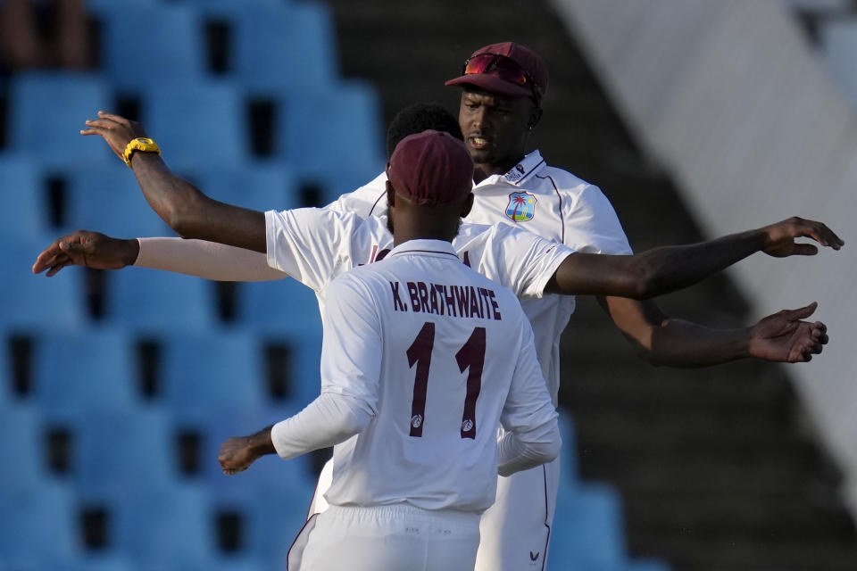 West Indies's bowler Jason Holder, back, celebrates with West Indies's bowler Alzarri Joseph, after dismissing South Africa's captain Temba Bavuma for a duck during the second day of the first test cricket match between South Africa and West Indies, at Centurion Park in Pretoria, South Africa, Wednesday, March 1, 2023. (AP Photo/Themba Hadebe)