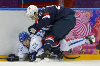 Finland forward Sakari Salminen and USA defenseman Kevin Shattenkirk crash the boards during the first period of the men's bronze medal ice hockey game at the 2014 Winter Olympics, Saturday, Feb. 22, 2014, in Sochi, Russia. (AP Photo/Mark Humphrey)