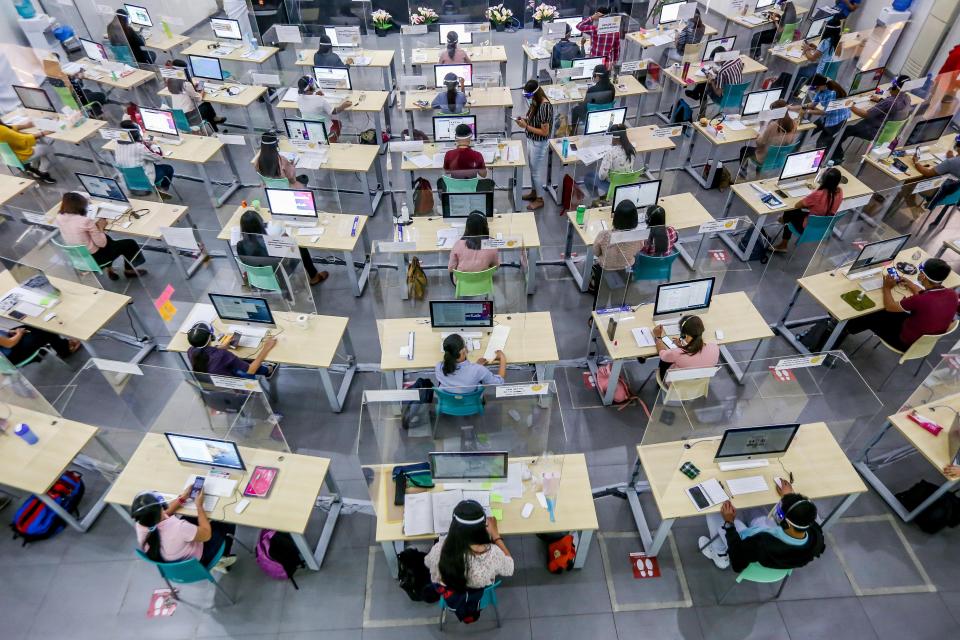 FILE PHOTO: High angled view of licensed teachers answering calls to assist students inside the Tele-Aral Center in Manila, the Philippines on Oct. 6, 2020. (Photo: Xinhua/Rouelle Umali via Getty Images)
