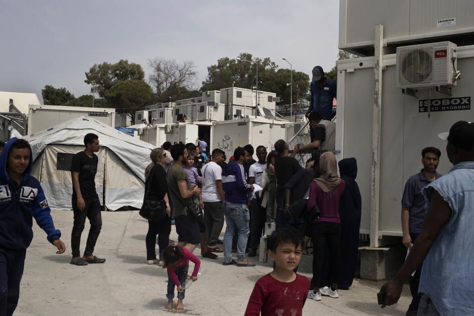 FILE - In this Friday, May 4, 2018 file photo, migrants and refugees wait outside the UNHCR offices for their papers, inside the camp of Moria, Lesbos island, Greece. European governments breathed a sigh of relief as the European Union reached a deal with Turkey designed to stop hundreds of thousands of refugees and migrants heading into the heart of Europe. For many of those who had fled war, hunger and poverty hoping for a bright future on the continent, the deal shattered their dreams. (AP Photo/Petros Giannakouris, File)