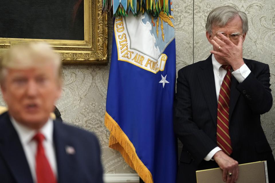 White House national security adviser John Bolton, right, listens to President Donald Trump in the Oval Office at the White House on July 18, 2019.
