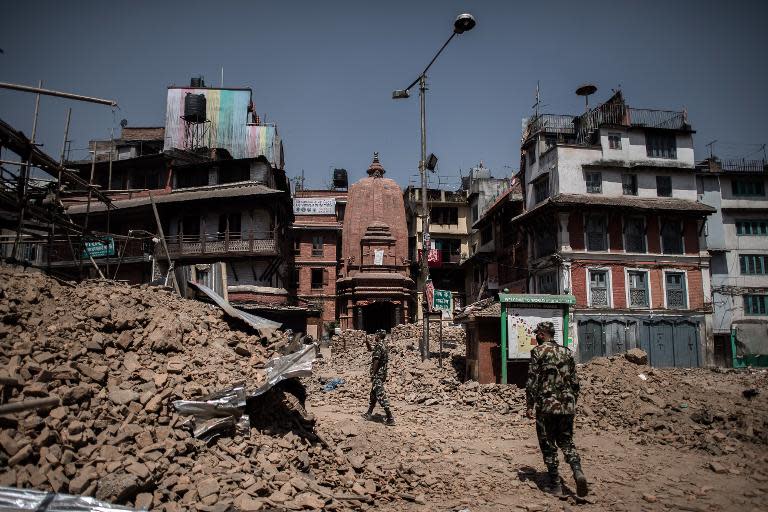 Nepalese soldiers inspect the debris after last month's massive earthquake destroyed several buildings at Dunbar Square in Kathmandu, on May 3, 2015