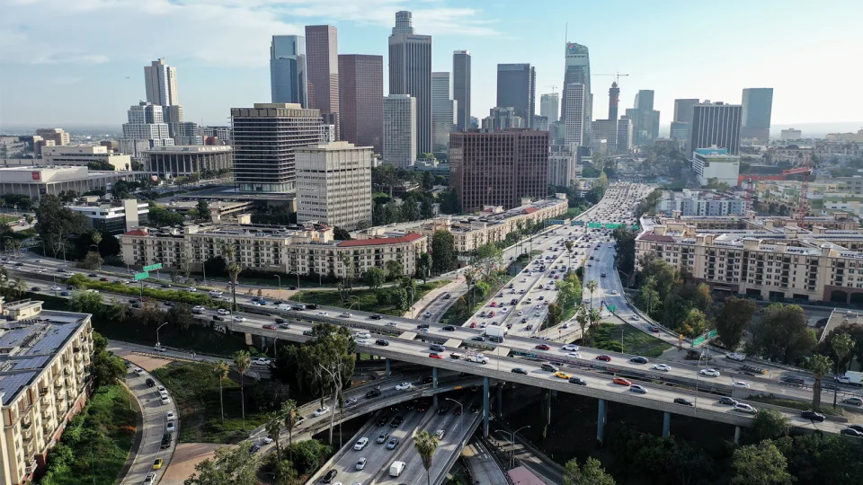 An aerial view of vehicles driving near downtown Los Angeles. 