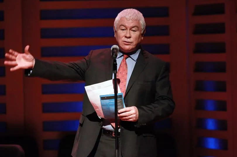 Sean Rafferty at a microphone speaking on stage