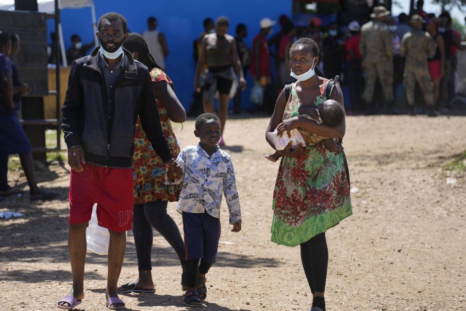 <span class="caption">Migrants, many from Haiti, walk on the grounds of a government shelter during their journey through Panama trying to reach the United States in October 2021.</span> <span class="attribution"><span class="source">(AP Photo/Arnulfo Franco)</span></span>