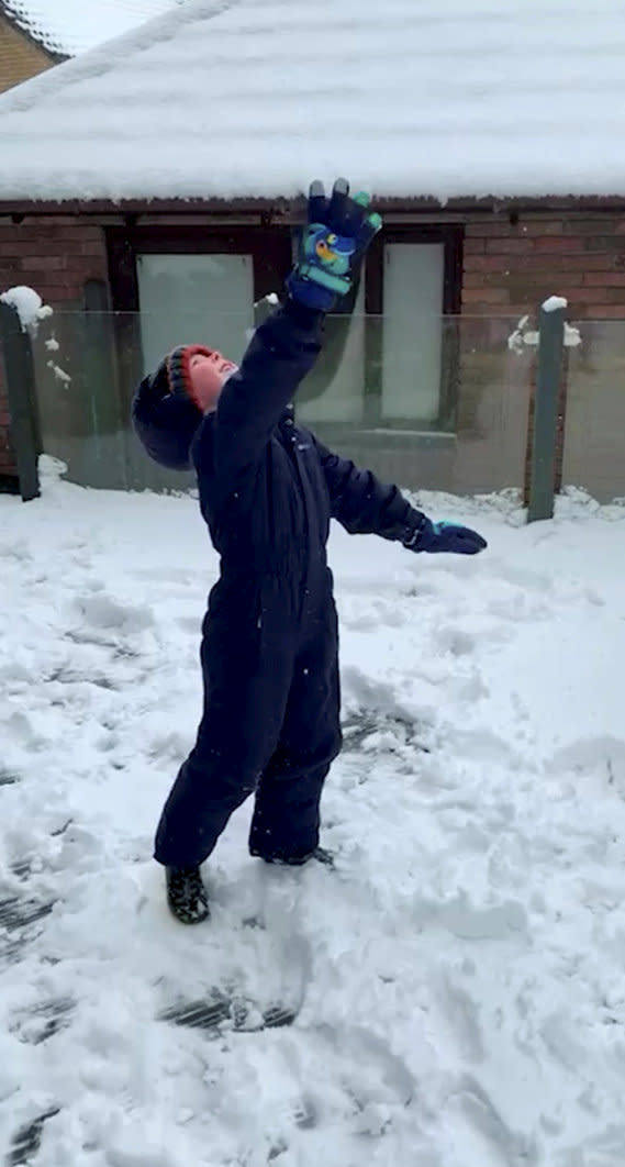 A video grab of six-year-old Dylan throwing the snowball up in the air. (SWNS)
