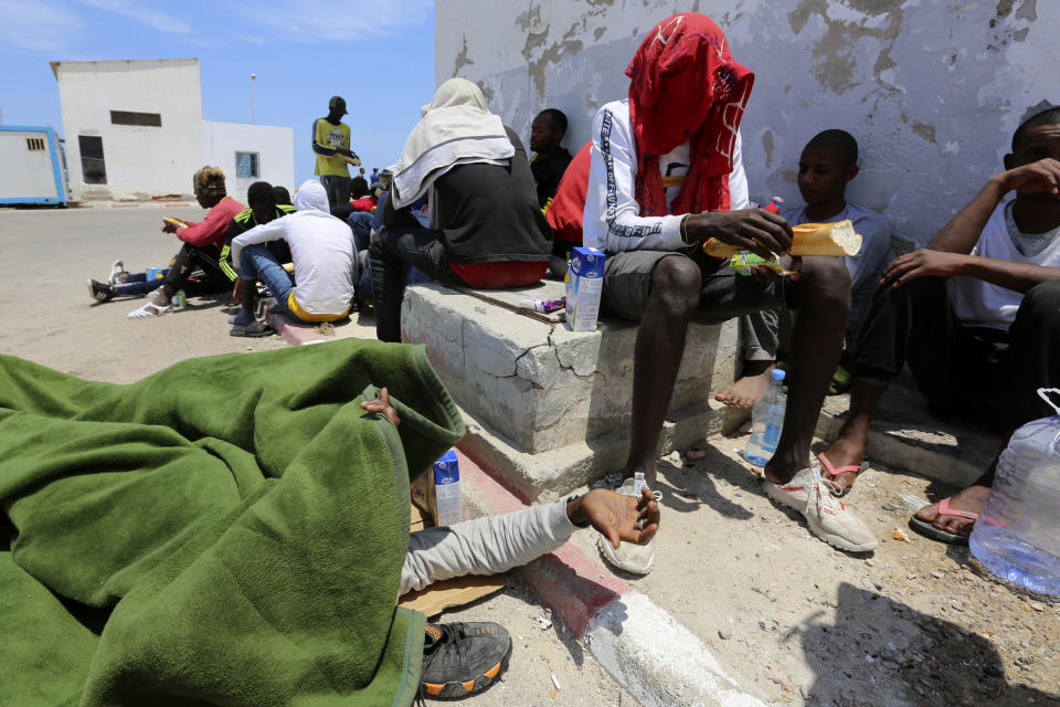 Rescued migrants wait in Ben Guerdane, southern Tunisia, Saturday June 12, 2021. Since the beginning of the year, over 600 people have died on the stretch of central Mediterranean coastline from Libya into Tunisia trying to reach Europe, according to the International Organization for Migration. (AP Photo/Mehdi El Arem)