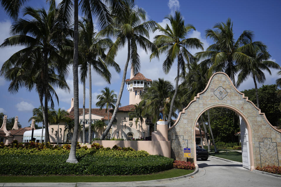 FILE - A security car blocks the drive at the entrance to former President Donald Trump's Mar-a-Lago estate in Palm Beach, Fla., March 29, 2023. An employee of Donald Trump's Mar-a-Lago estate, Carlos De Oliveira, is expected to make his first court appearance Monday, July 31, on charges accusing him of scheming with the former president to hide security footage from investigators probing Trump's hoarding of classified documents. (AP Photo/Rebecca Blackwell, File)