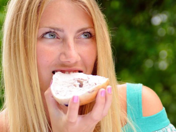 woman eating bagel