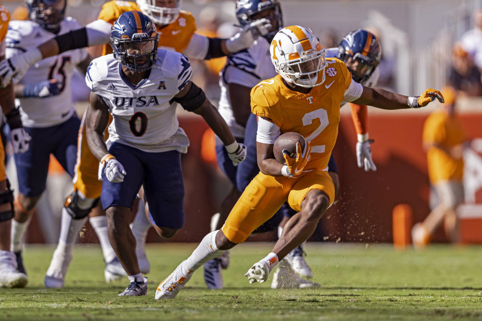 Tennessee running back Jabari Small (2) outruns UTSA safety Rashad Wisdom (0) during the first half of an NCAA college football game Saturday, Sept. 23, 2023, in Knoxville, Tenn. (AP Photo/Wade Payne)