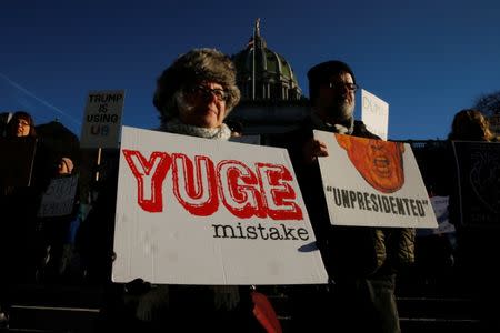 People protest against U.S. President-elect Donald Trump as electors gather to cast their votes for U.S. president at the Pennsylvania State Capitol in Harrisburg, Pennsylvania, U.S. December 19, 2016. REUTERS/Jonathan Ernst