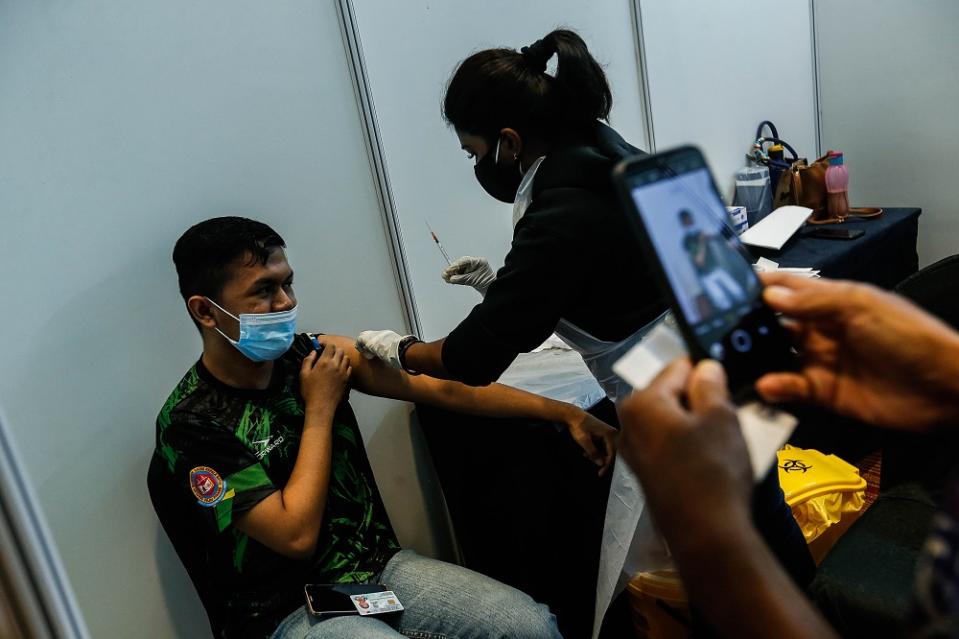 A teenager receives his Covid-19 vaccination shot at the Subterranean Penang International Convention and Exhibition centre in Bayan Baru September 22, 2021. Those in the 12 to 15 age group will begin their vaccinations on Wednesday. —Picture by Sayuti Zainudin