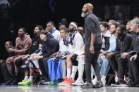 Brooklyn Nets forward Dorian Finney-Smith, left, and guard Spencer Dinwiddie, second from left, watch the game from the bench during the first half of an NBA basketball game against the Phoenix Suns, Tuesday, Feb. 7, 2023, in New York. (AP Photo/Mary Altaffer)