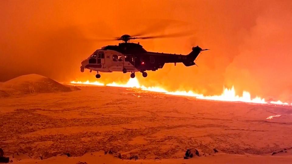 PHOTO: This image made from video provided by the Icelandic Coast Guard shows its helicopter flying near magma running on a hill near Grindavik on Iceland's Reykjanes Peninsula sometime around late Monday, Dec. 18, or early Tuesday, Dec. 19, 2023. (Icelandic Coast Guard via AP)