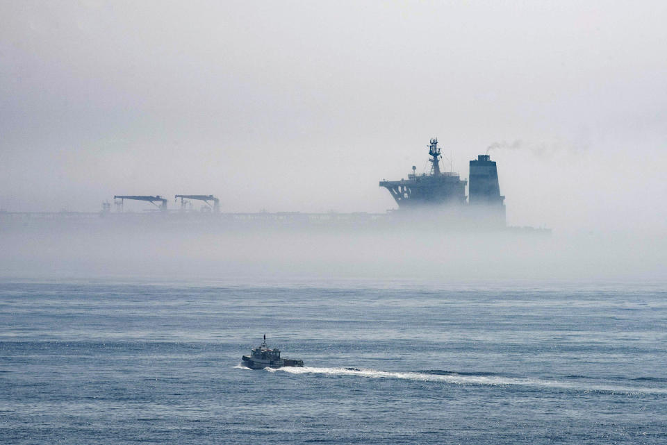 A view of the Grace 1 supertanker is seen through the sea fog, in the British territory of Gibraltar, Thursday, Aug. 15, 2019, seized last month in a British Royal Navy operation off Gibraltar. The United States moved on Thursday to halt the release of the Iranian supertanker Grace 1, detained in Gibraltar for breaching EU sanctions on oil shipments to Syria, thwarting efforts by authorities in London and the British overseas territory to defuse tensions with Tehran. (AP Photo/Marcos Moreno)