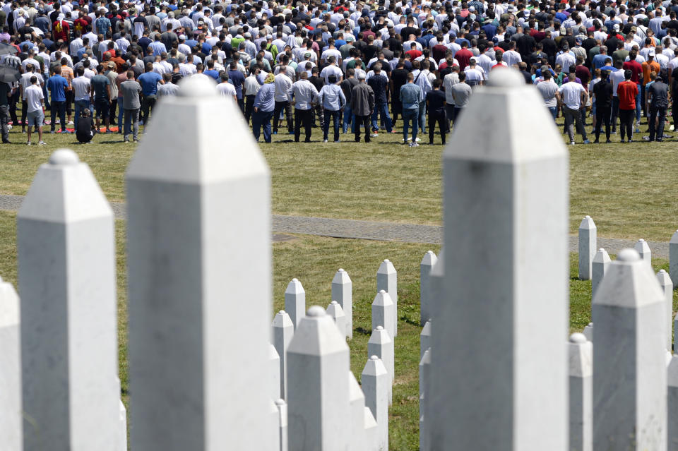 Bosnians attend the funerals of nine massacre victims in Potocari, near Srebrenica, Bosnia, Saturday, July 11, 2020. Mourners converged on the eastern Bosnian town of Srebrenica for the 25th anniversary of the country's worst carnage during the 1992-95 war and the only crime in Europe since World War II that has been declared a genocide. (AP Photo/Kemal Softic)