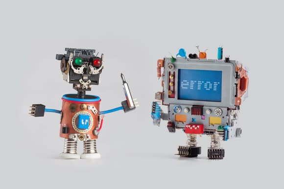 Two robots hanging out side by side, one with an error message displayed.