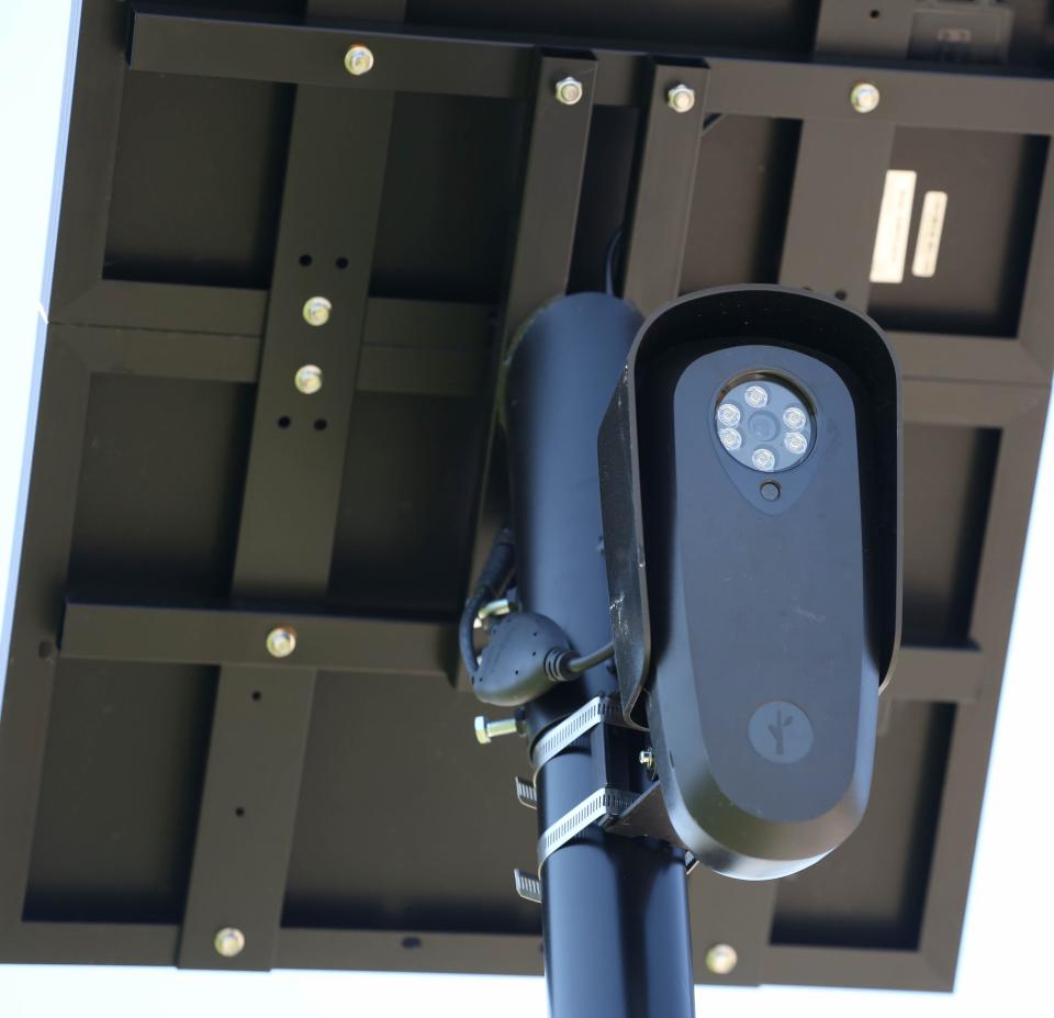 A Flock automatic license plate reader camera, owned by Penn Square Mall, stands near the south mall entrance.