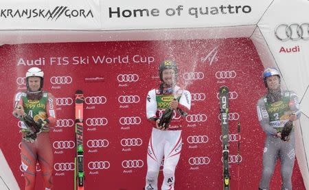 Alpine Skiing - FIS Alpine Skiing World Cup - Men's Giant Slalom - Kranjska Gora, Slovenia - March 3, 2018 - Marcel Hirscher of Austria celebrates with Henrik Kristoffersen of Norway and Alexis Pinturaulton on the podium. REUTERS/Borut Zivulovic