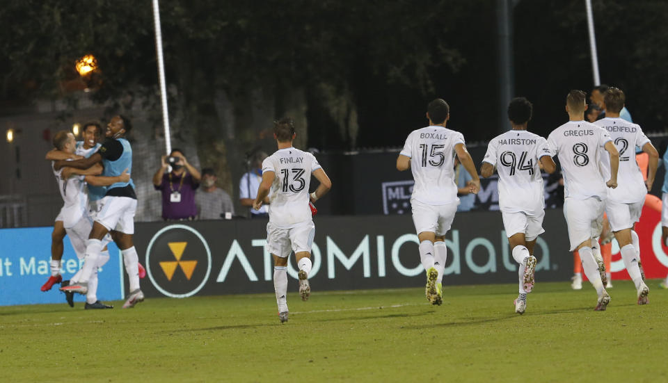 Minnesota United celebrates a win after a series of penalty kicks over Columbus Crew during the second half of an MLS soccer match in Kissimmee, Fla., Tuesday, July 28, 2020. (AP Photo/Reinhold Matay)