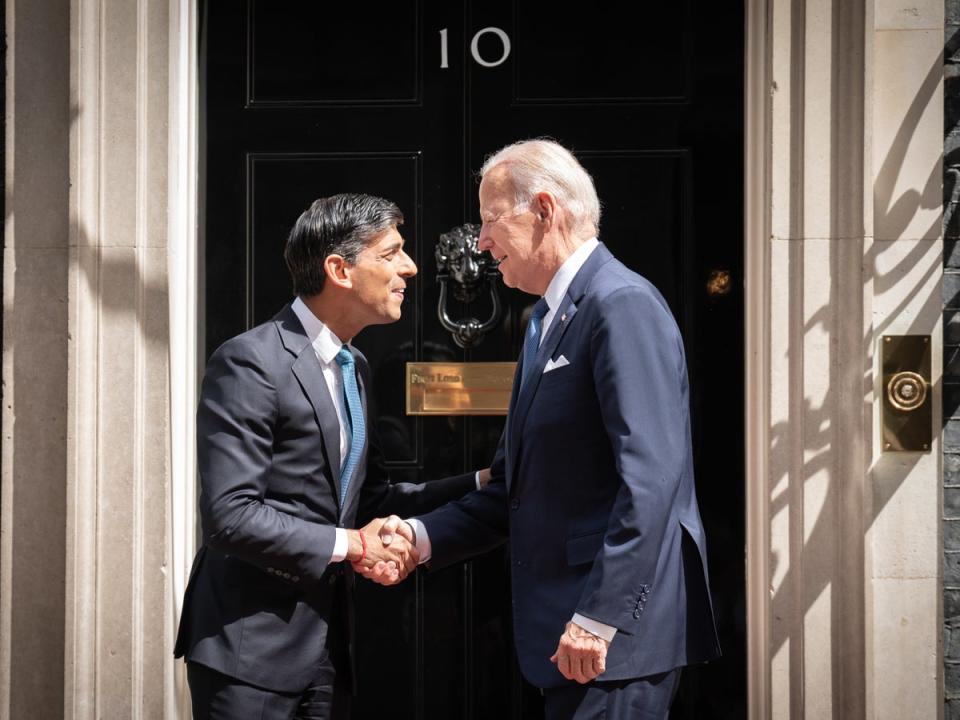 Rishi Sunak looking up to 6ft tall Joe Biden as they meet outside No 10 (PA)