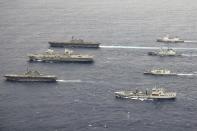 Pictured left to right; RFA Tidespring, JS Izumo, HMCS Winnipeg, HMS Queen Elizabeth, HMS Defender, JS Ise, and the HNLMS Evertsen. UK Royal Navy Carrier Strike Group 21 HMS Queen Elizabeth, HMS Defender, RFA Tidespring and HNLMS Evertsen from CSG21 sails with Japanese ships JS Izumo and JS Ise along with the Canadian ship HMCS Winnipeg in the Pacific Ocean, Sept. 2021. (UK Ministry of Defence via AP)