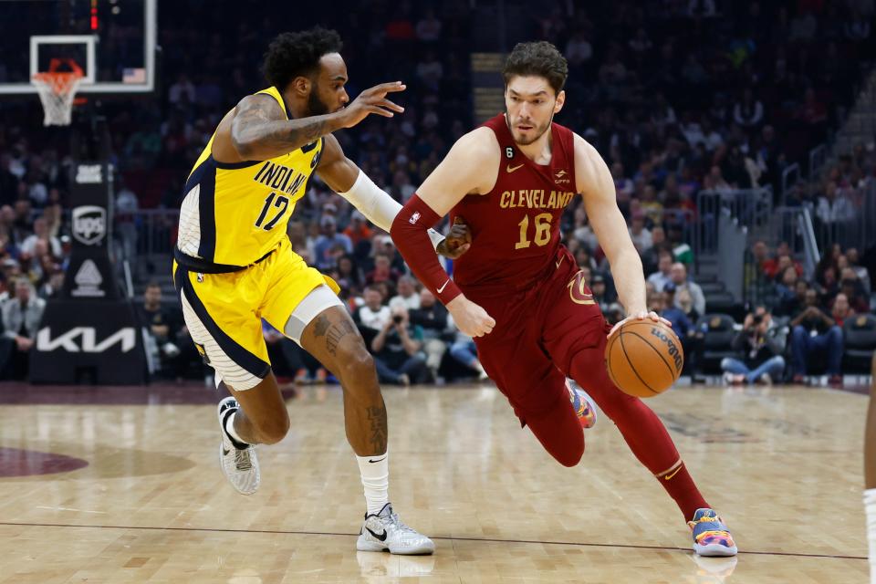 Cleveland Cavaliers forward Cedi Osman (16) drives against Indiana Pacers forward Oshae Brissett (12) during the first half of an NBA basketball game, Sunday, April 2, 2023, in Cleveland. (AP Photo/Ron Schwane)