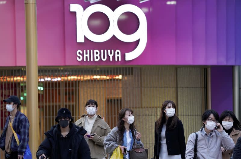 Pedestrians wearing protective masks are pictured in Tokyo