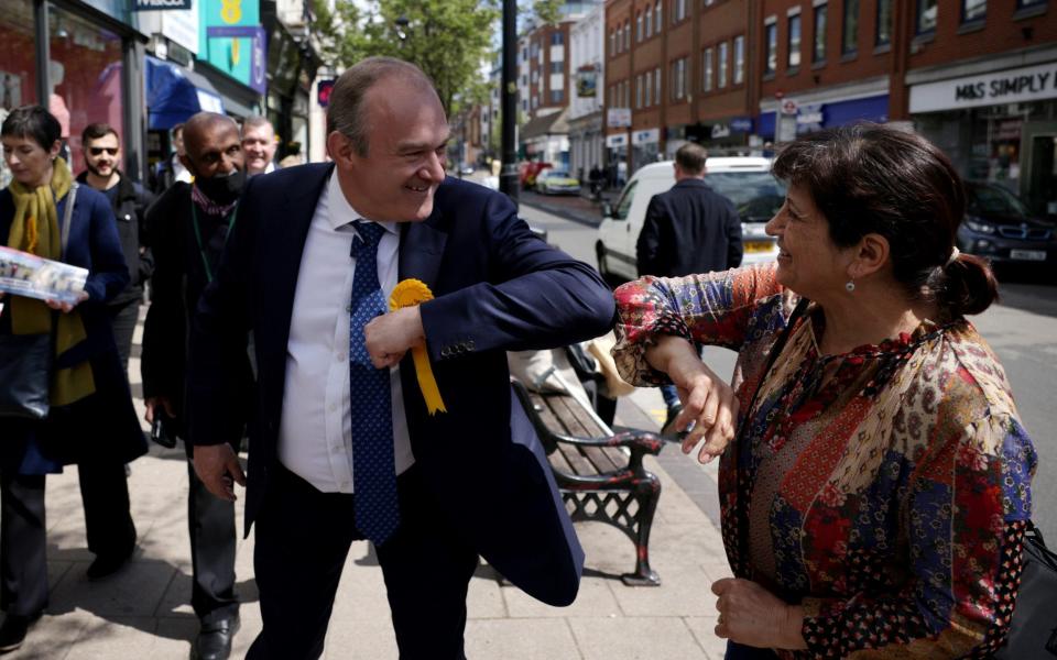 Ed Davey, Leader of the Liberal Democrats bumps elbows with a member of the public  - Dan Kitwood