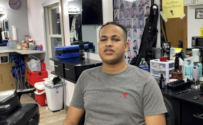 In this image taken from video, Saul Perez talks with the Associated Press at a barbershop in Leominster, Mass., Wednesday, March 15, 2023. Perez was at the barbershop when Francisco Torres walked into the business and said he wanted someone to shoot him with an automatic weapon stored in the trunk of his car. Torres left the shop and police were called. Just over a week later, Torres was arrested for allegedly trying to stab a flight attendant on a flight from Los Angeles to Boston. The case has directed attention to passengers with mental health challenges. (AP Photo/Michael Casey)