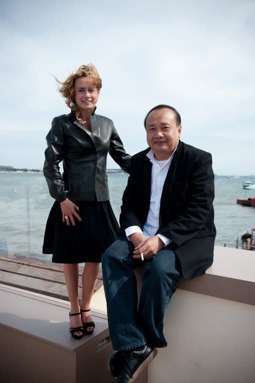 French actress Sandrine Bonnaire (L) and Cambodian-French director Rithy Panh (R) pose on May 14, 2010 in Cannes during the 63rd Cannes Film Festival. A documentary on relatives wiped out in the Khmer Rouge's tyrannical grip on Cambodia in the 1970s earned Panh a major prize at the 2013 Cannes Film Festival on Saturday