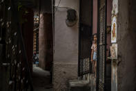 A young girl stands at the entrance of her house next to the house of a 9-year-old girl from the lowest rung of India's caste system who according to her parents and protesters, was raped and killed earlier this week, in New Delhi, India, Thursday, Aug. 5, 2021. (AP Photo/Altaf Qadri)